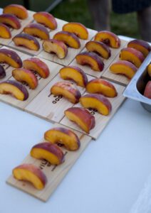 Grilled peaches on a wood grilling plank
